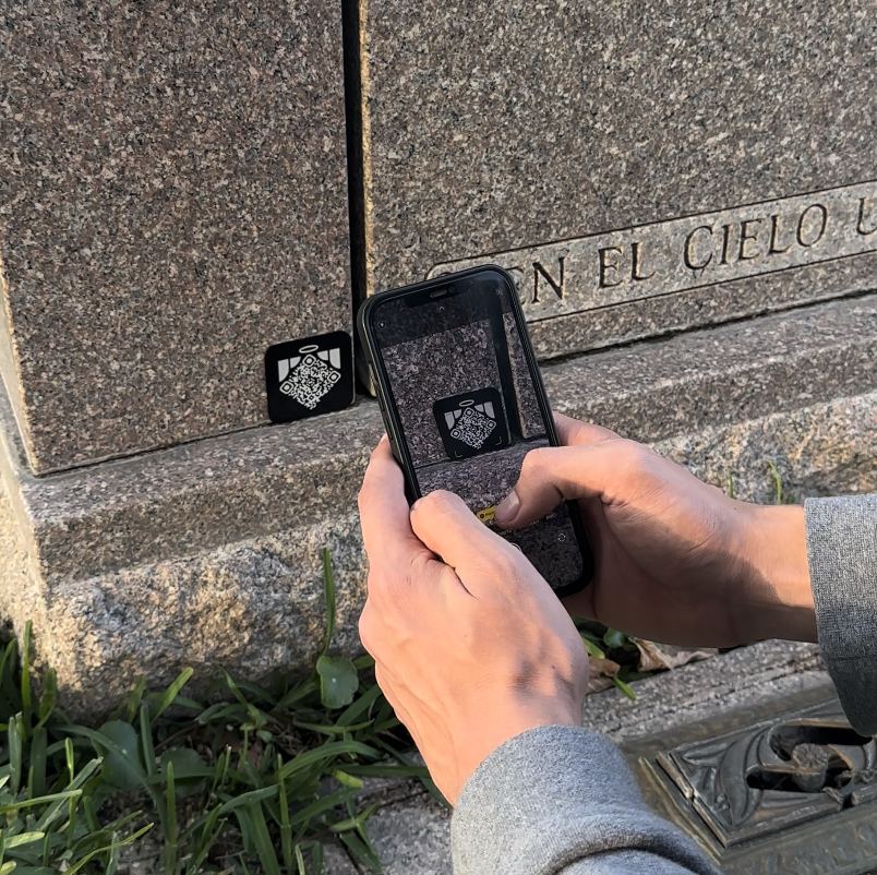 Visitor scanning a Memoriv QR medallion with a phone